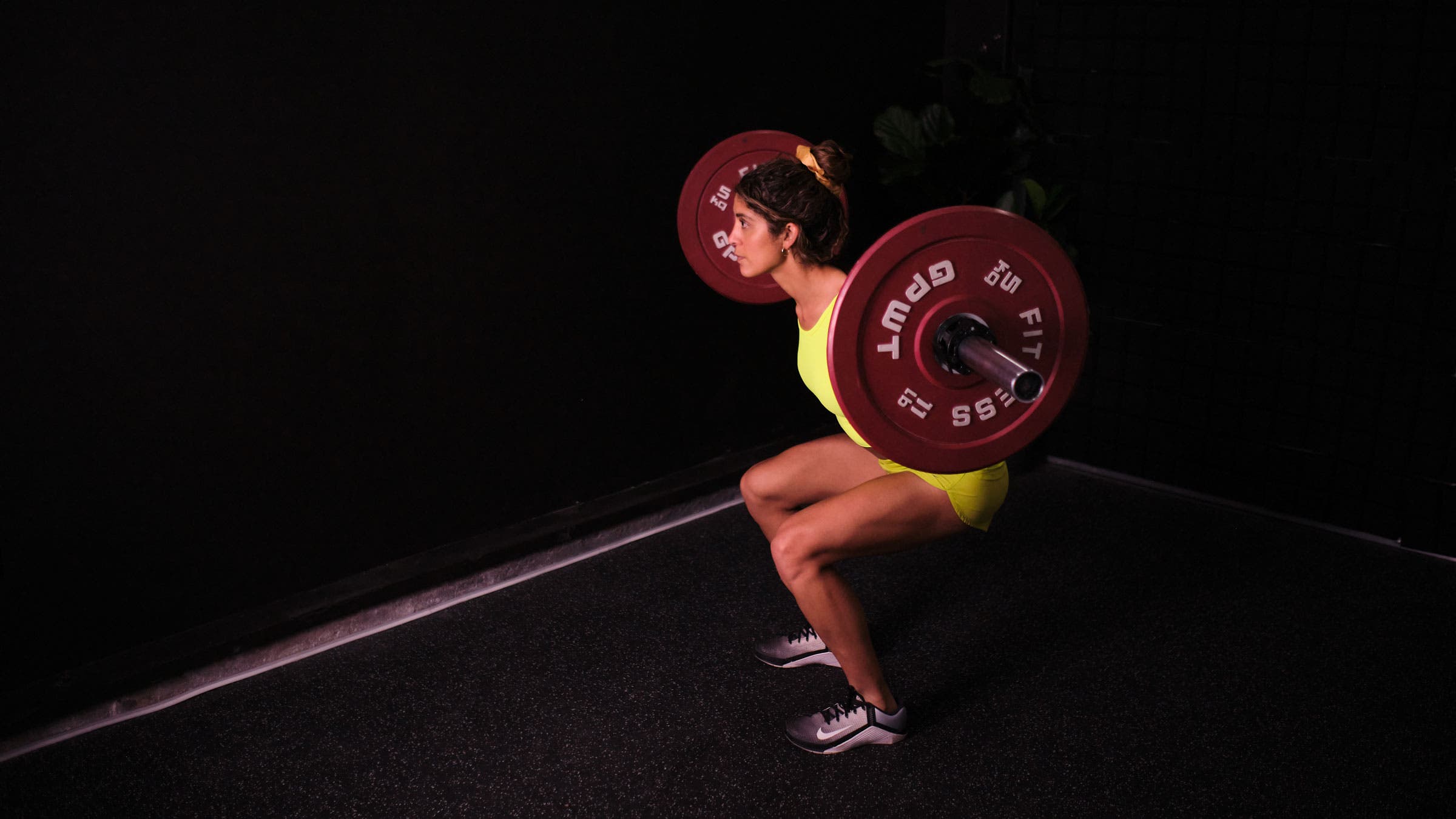 Woman demonstrates a squat as a hip hinge exercise