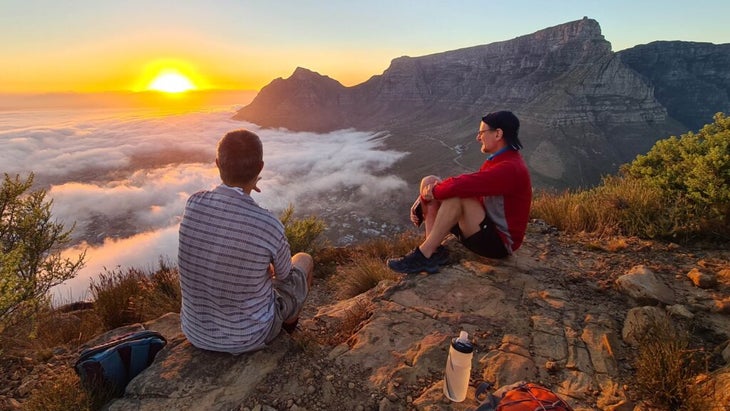 Two men watching the sunrise in Cape Town