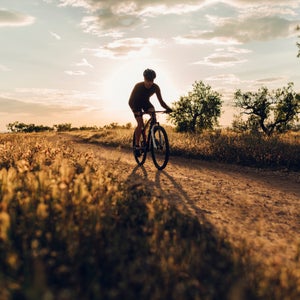 Mountain bike downhill rider in action at sunset