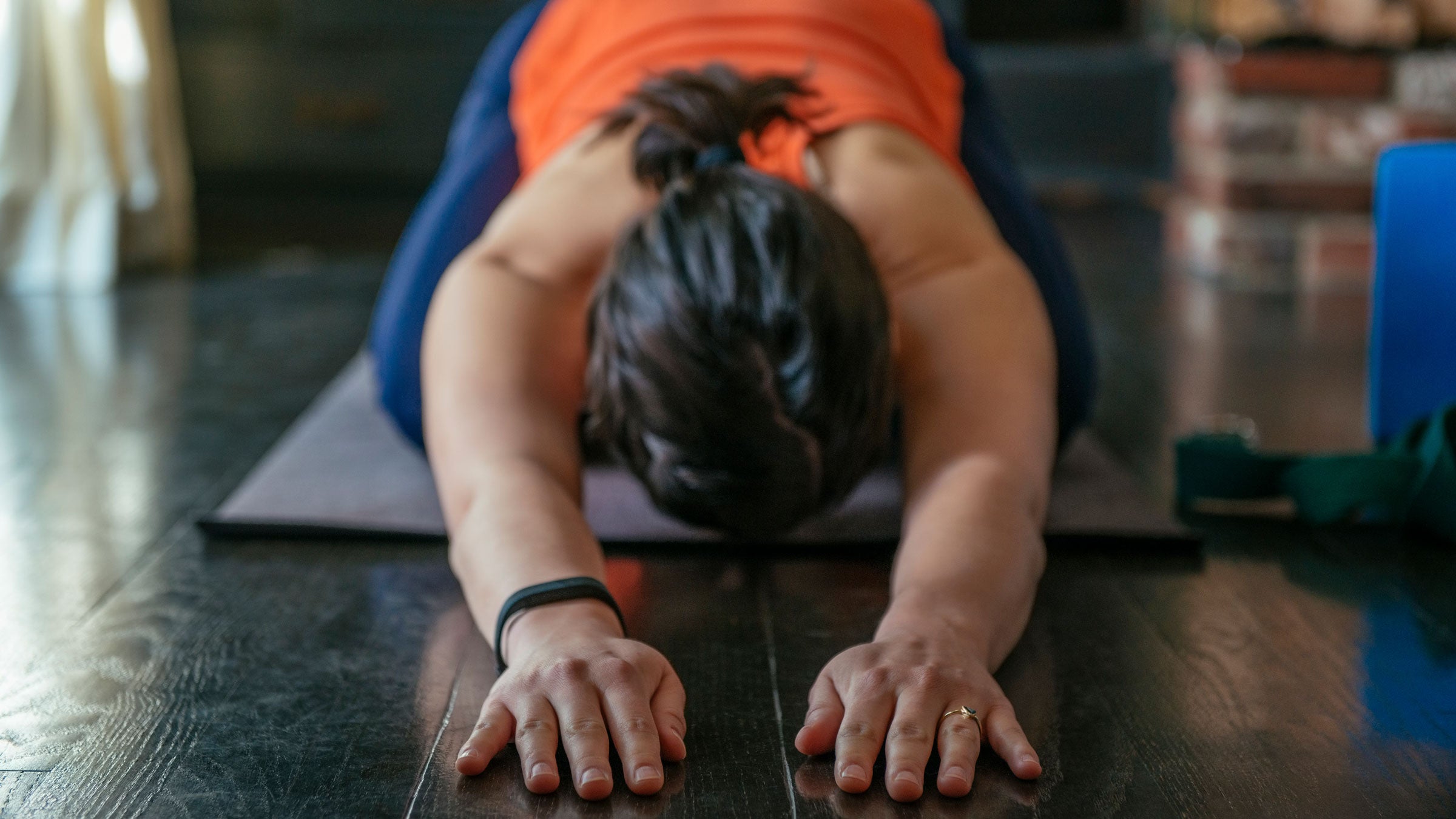 Woman practices child's pose during a yoga class