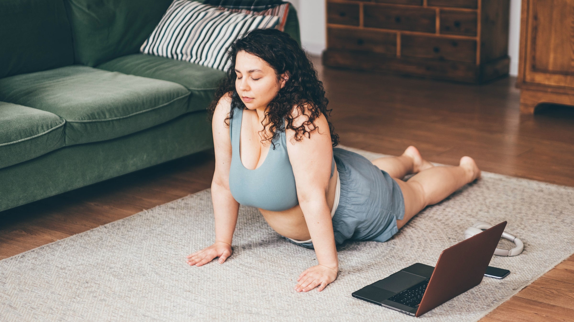 Plus size woman doing yoga and meditation at home for body image