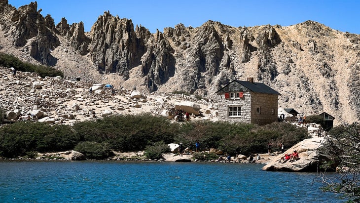 Argentina's Refugio Frey sit against craggy mountains and on the shores of an alpine lake
