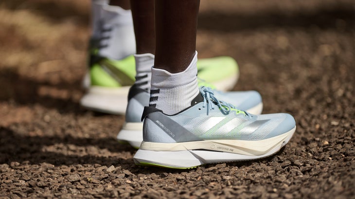 A runner with white socks wears the Adidas Boston 12
