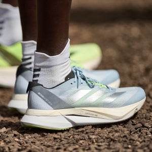 A runner with white socks wears the Adidas Boston 12