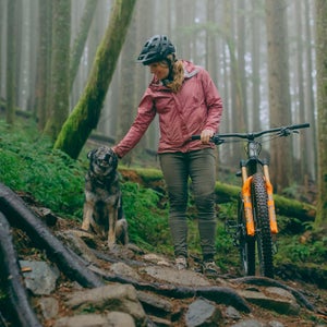 Alex Showerman with a dog and mountain bike