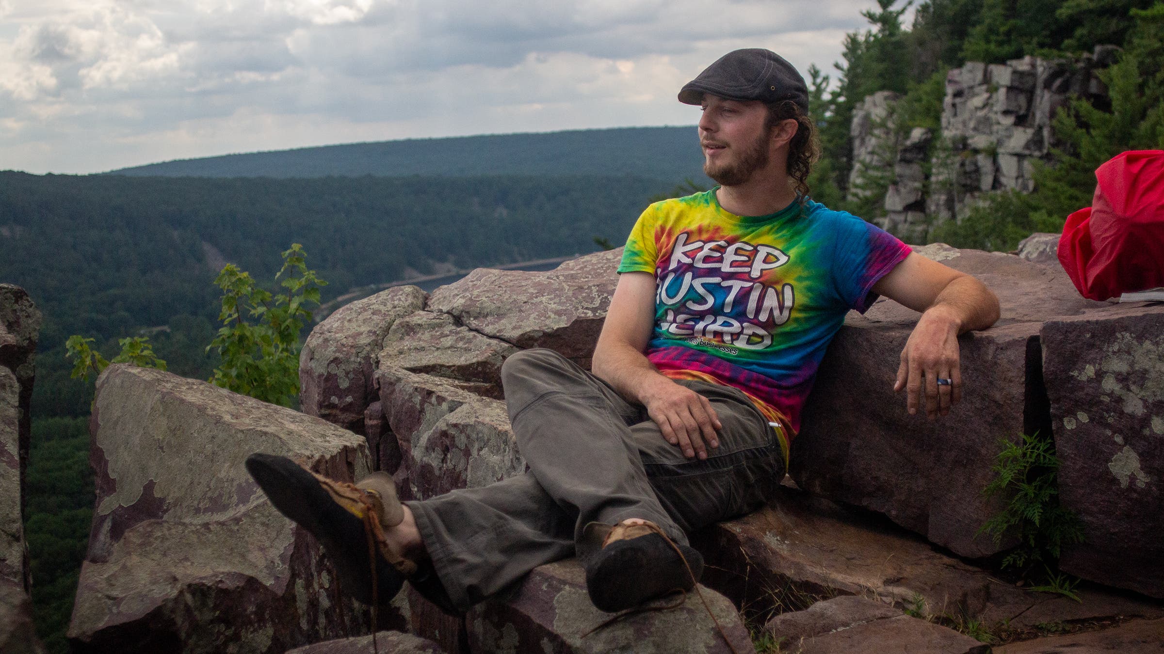 Howell relaxing in a tie-dyed shirt that says “Keep Austin Weird”