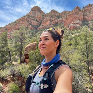 woman in a desert trail look off in the distance