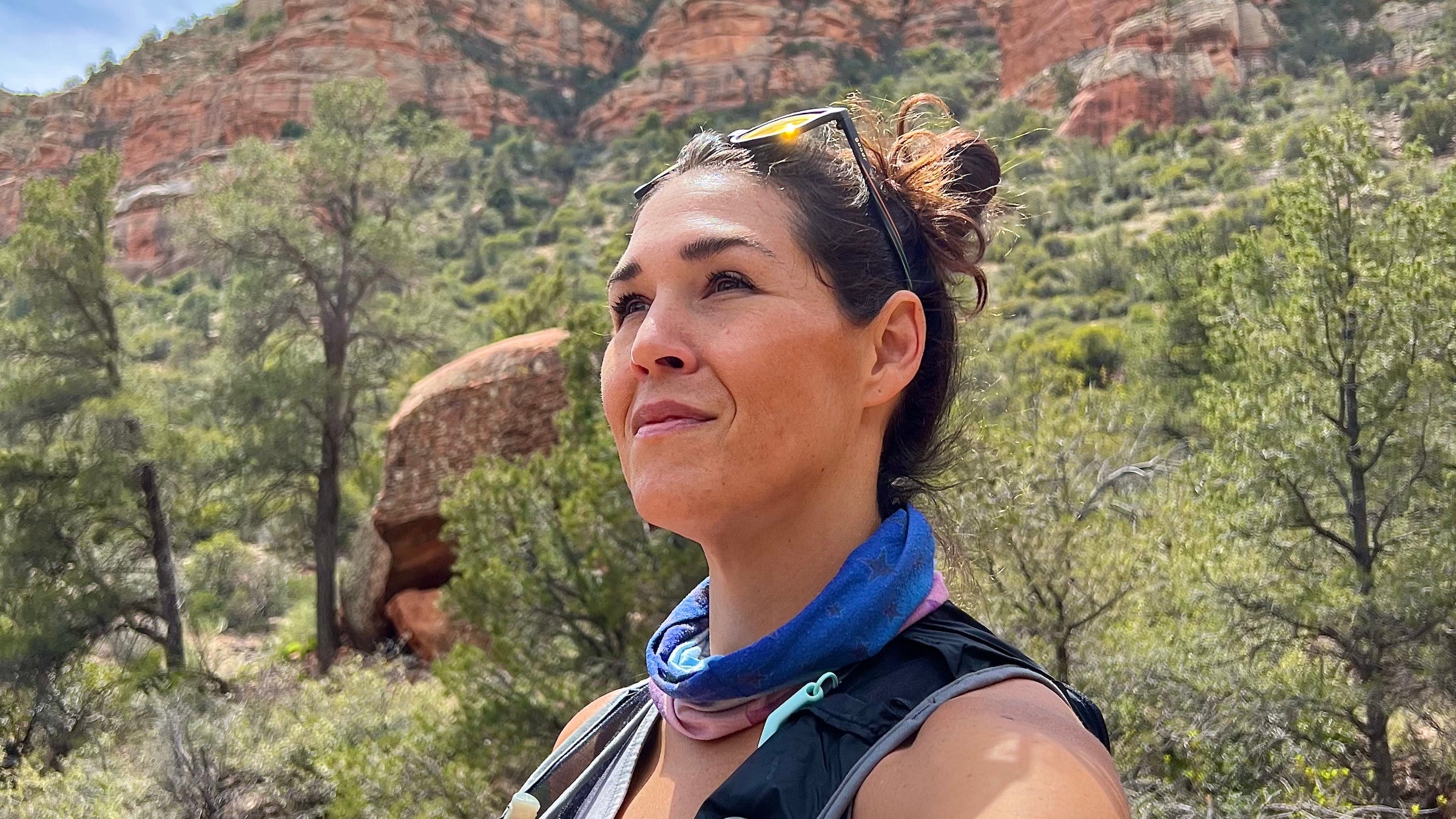 woman in a desert trail look off in the distance