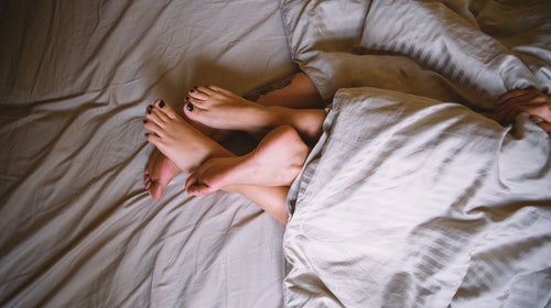 Couple in bed having sex