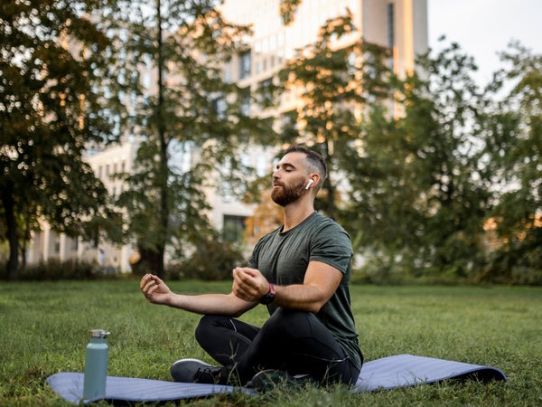 Man meditates outside