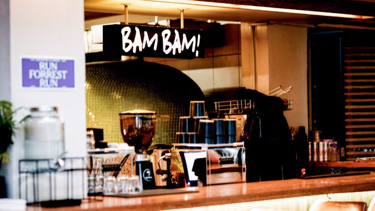  A cafe in the running store with a black sign hung that says BAM BAM