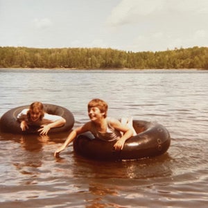Nick, right, gleefully celebrating a victory over his older sister, Laurie, in the annual tubing championship on Long Lost Lake