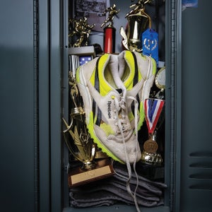 Old Reebok running shoes in a locker with trophies and medals