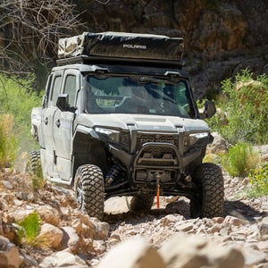 The Polaris Xpedition side-by-side driving off-road