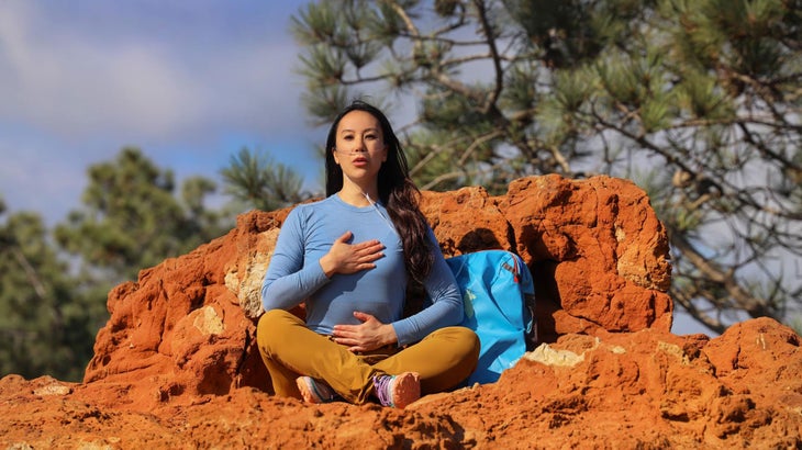 Woman demonstrates pursed lips breathing