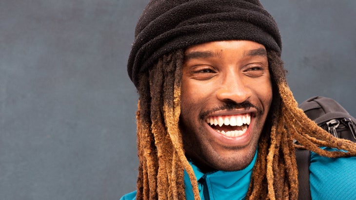 Ron Griswell, Black outdoor leader, smiling in black cap and blue jacket