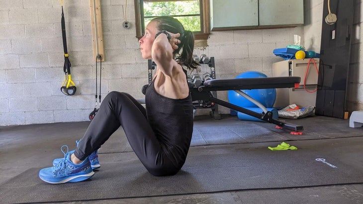 Woman demonstrates a sit-up