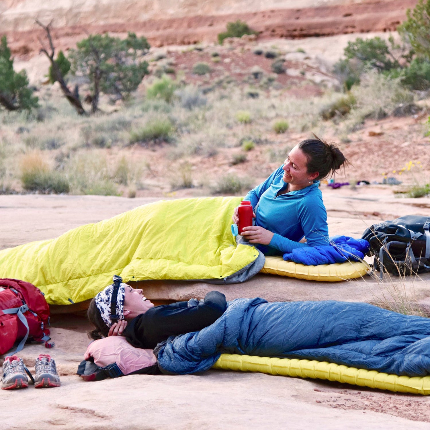 campers lying on rock