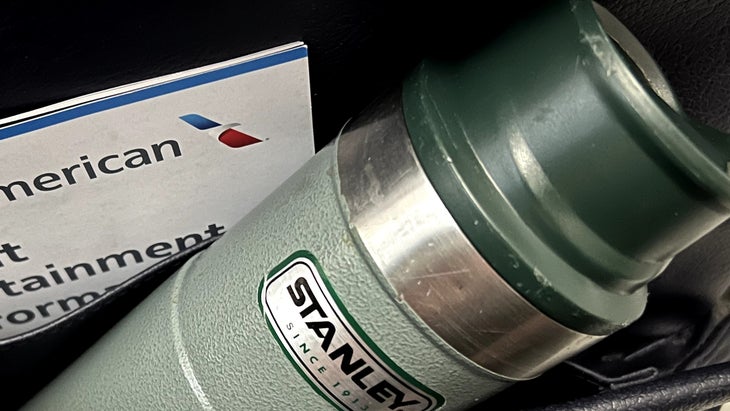 Stanley water bottle in seatback pocket on airplane; zero waste travel kit