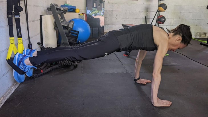 Woman practices a hip flexor exercise