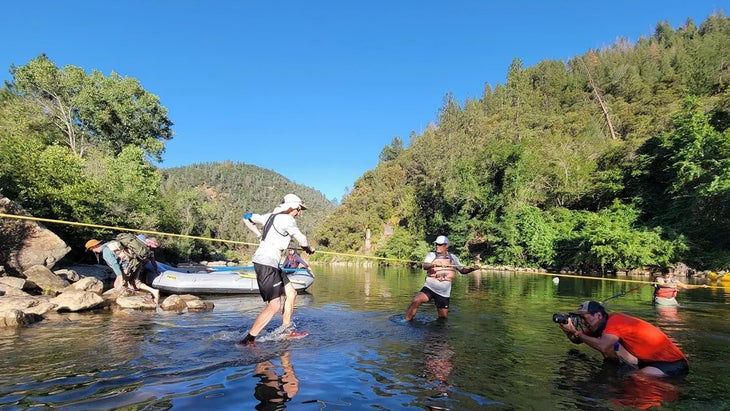 a man crosses the river in California with white clothes