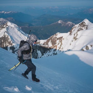 Gerardi descends a snow field with mountains in the background
