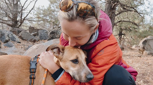 runner hugging her dog