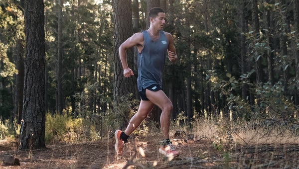 runner in woods wearing recycled-material shorts and top