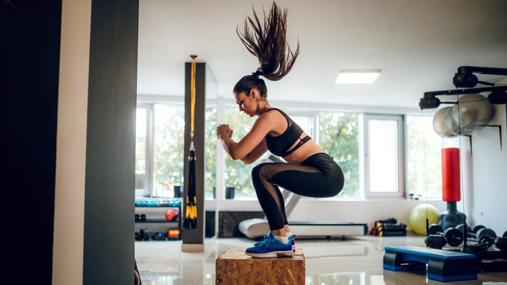 Woman does box jumps