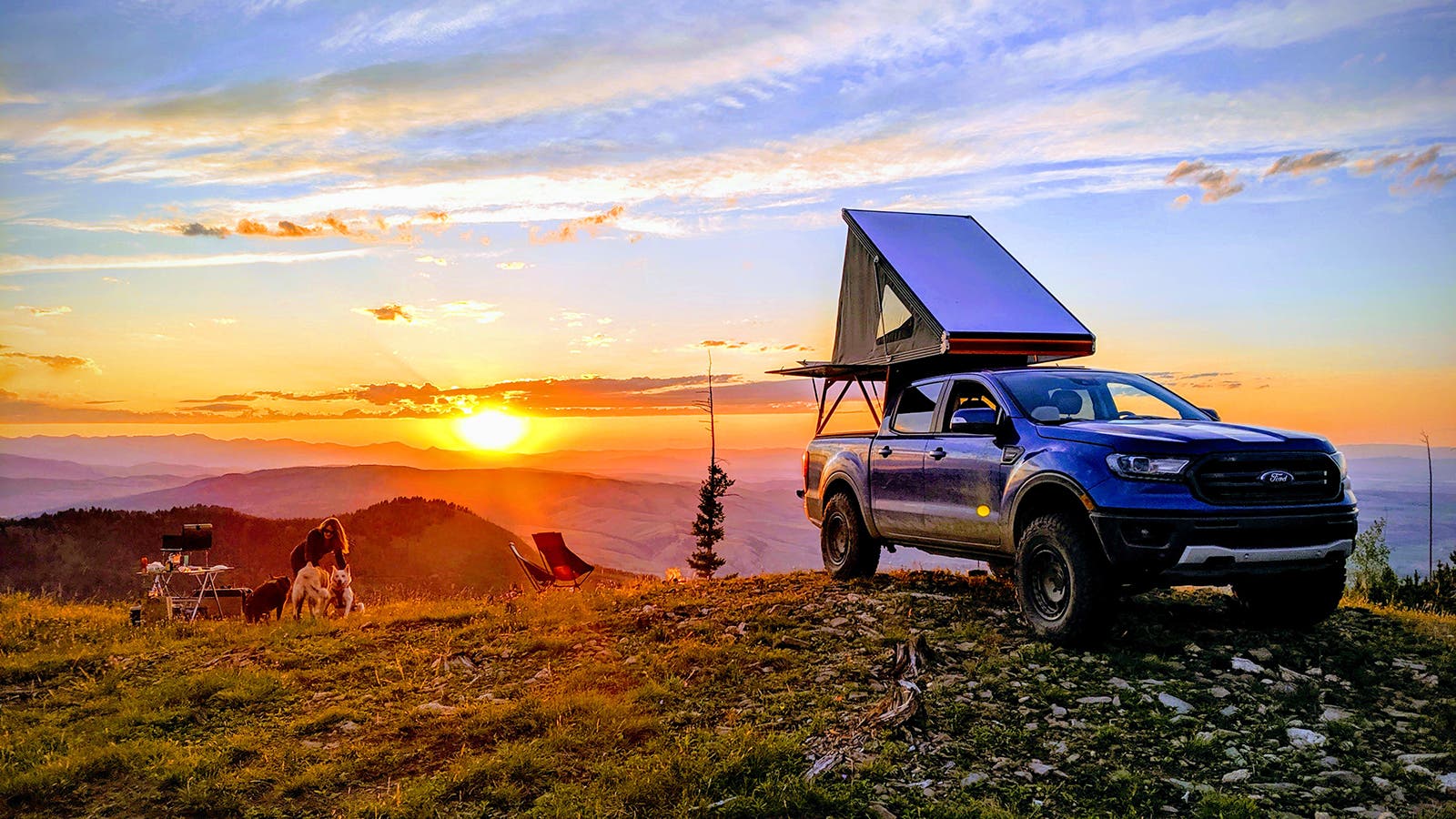 truck with pop-up tent in beautiful mountain sunset