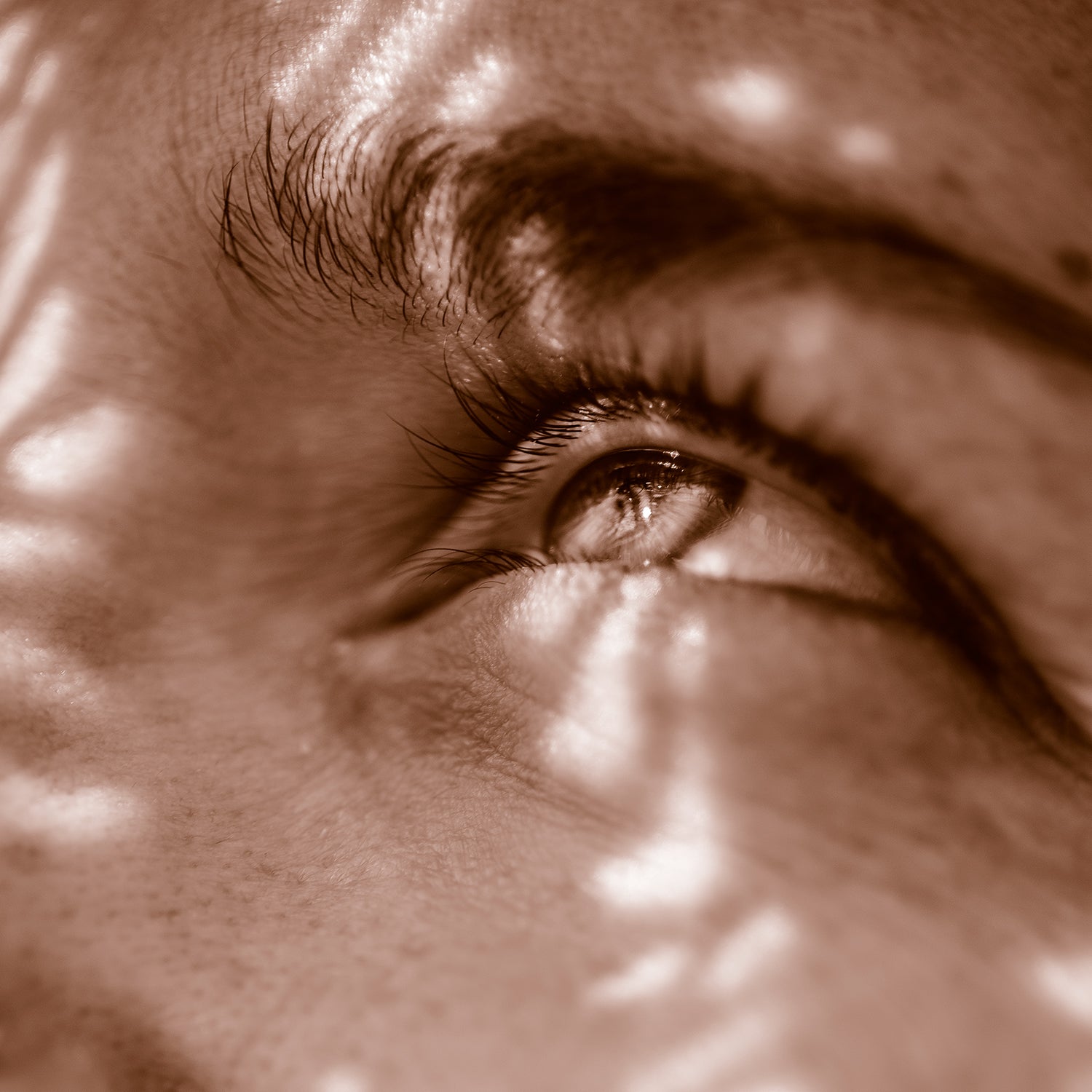 The stunning effects of wind and flood erosion on the we all of Lower Antelope Canyon Page Arizona; woman's eye looking to the light.