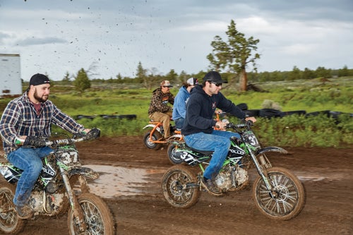 Bikers race on a muddy course