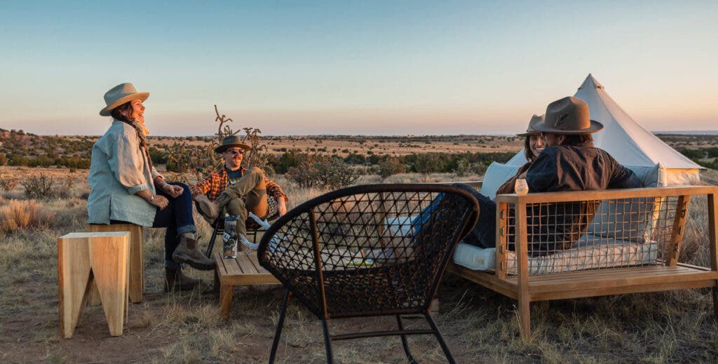 A group of friends hanging out on outdoor couches