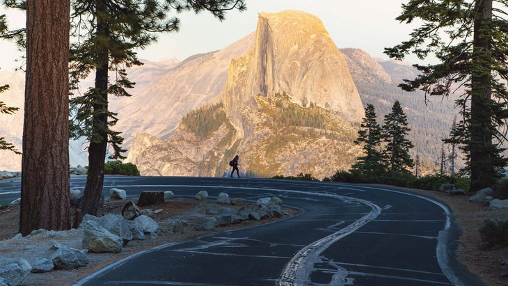 woman walks on Glacier Point Rd Yosemite