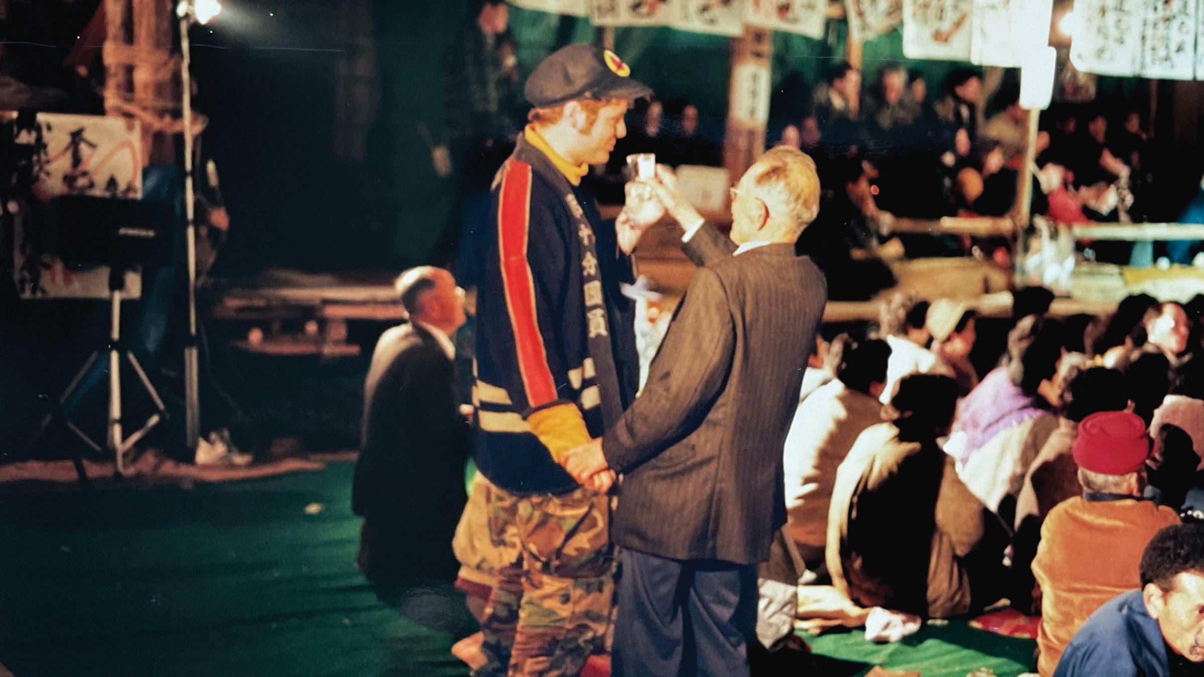 The author takes part in the Kabuki festival ritual of too much sake, with help from a generous village elder.