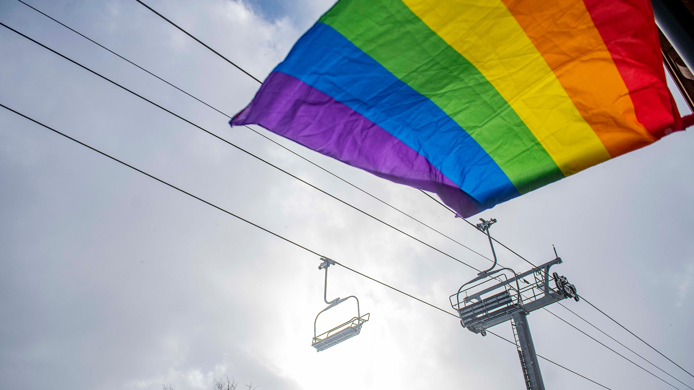 A pride flag waves in the wind under a lift in Mountain Village during Telluride Gay Ski Week in Mountain Village.