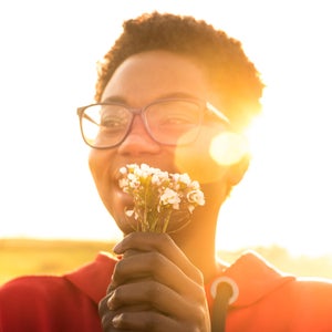 Person holding fresh white flowers in a field