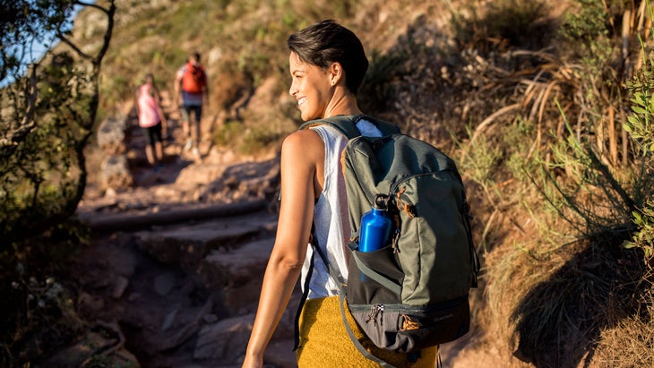 A woman rucking on a mountain