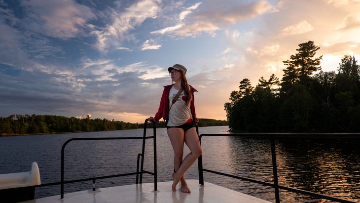 woman at sunset on a houseboat in Voyageurs National Park