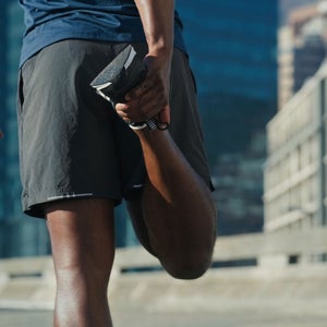 Man does a full-body stretch before a run
