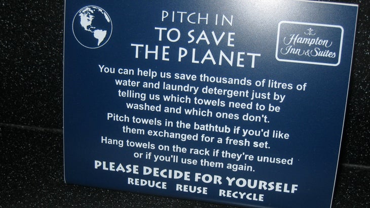 Hang towels to save the planet sign greenwashing