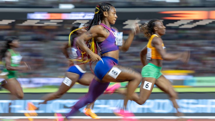 Women speeding along a track in a blurred sprint