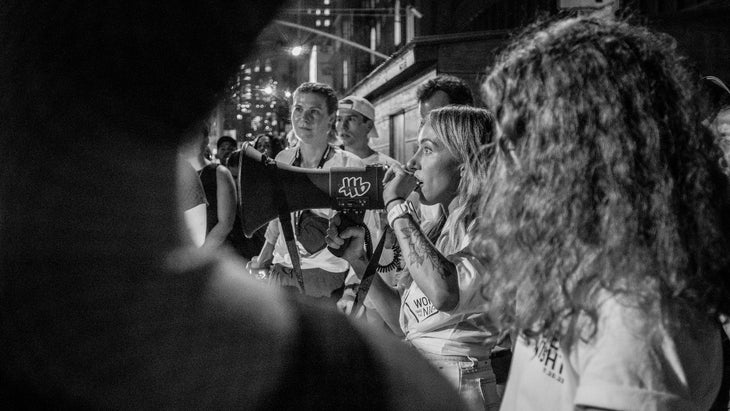 A woman organizer talks into a megaphone