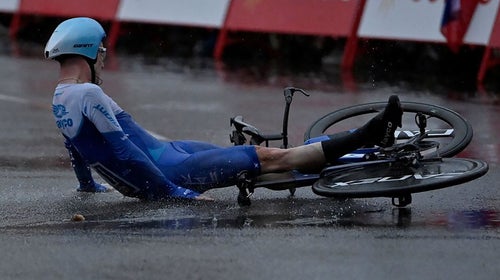 A cyclist crashes on his aerodynamic time trial bike.