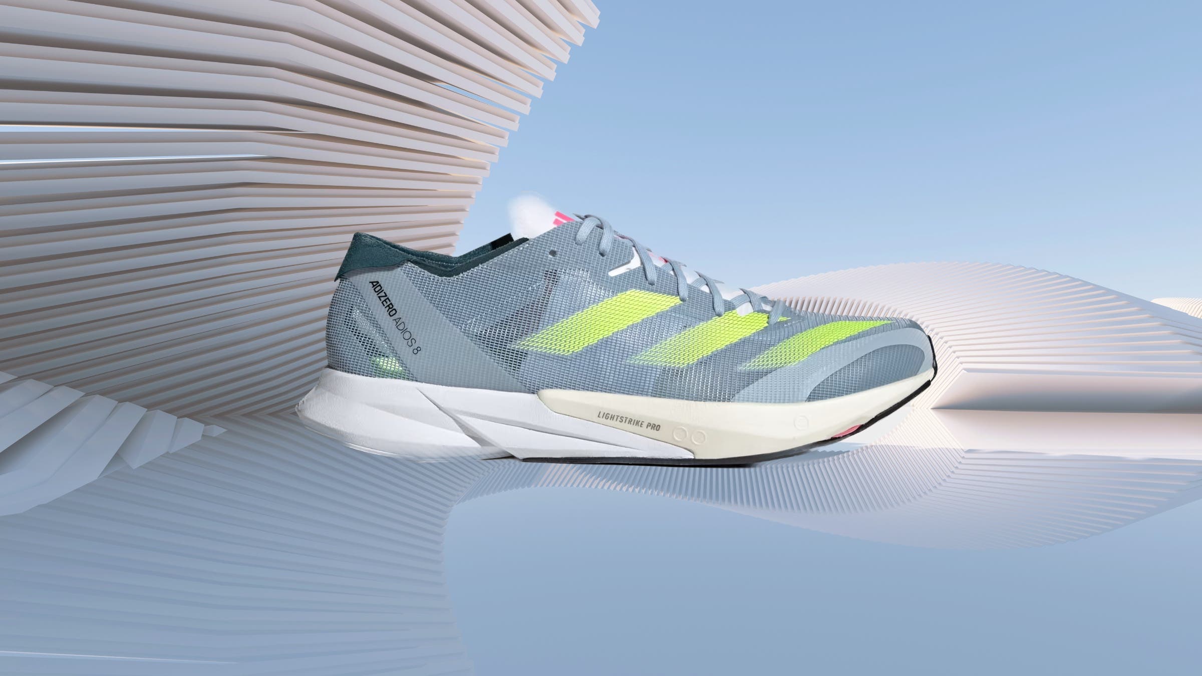 the adidas adios 8 shoe is gray with green stripes