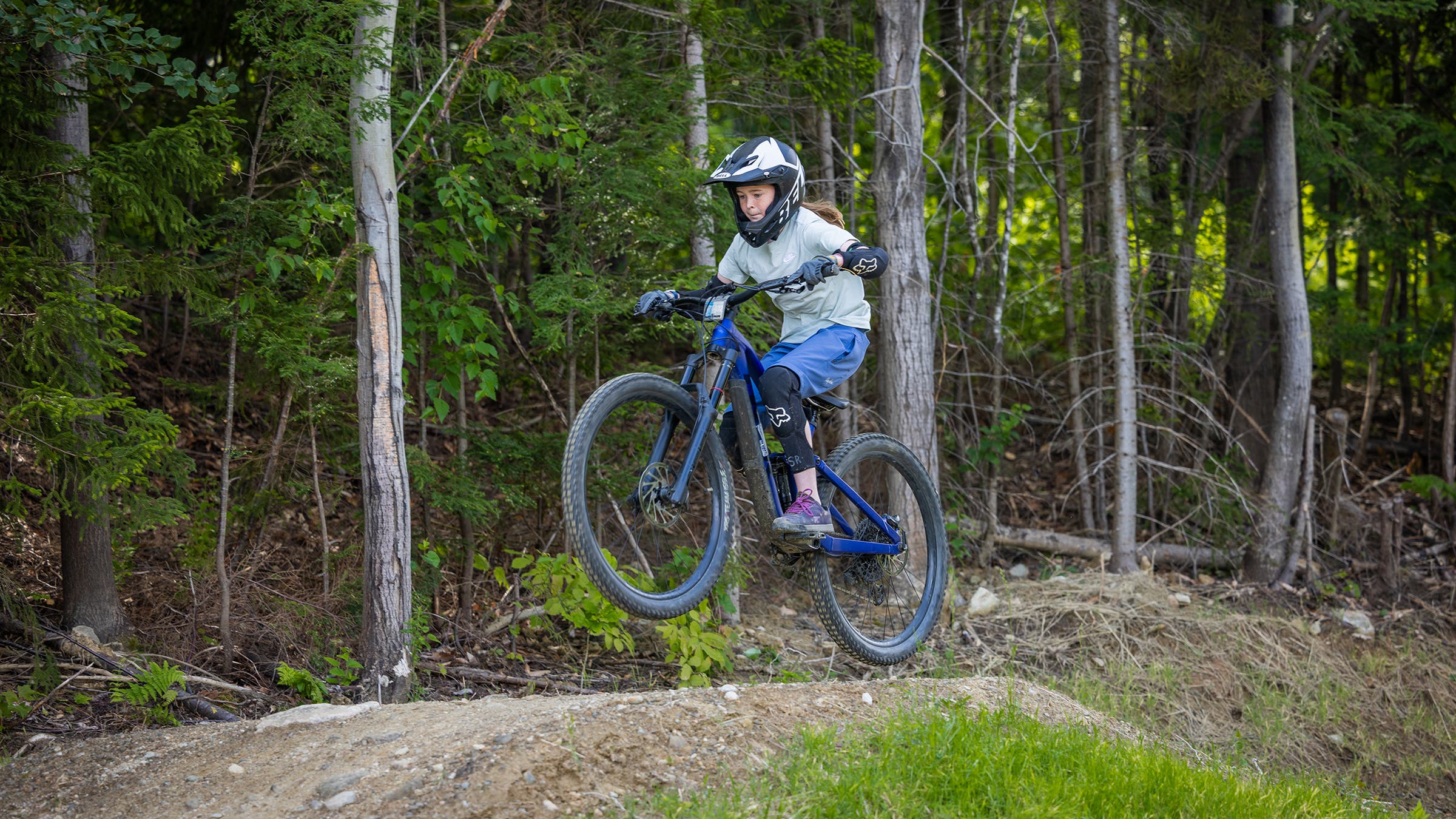 The author's daughter going over a jump