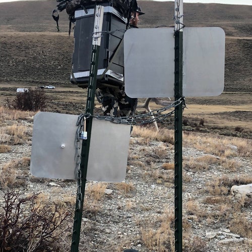 Two signs positioned a foot or two away from each other, connected by a chain.