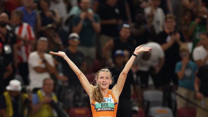 Runner celebrates in orange singlet after winning track world championship
