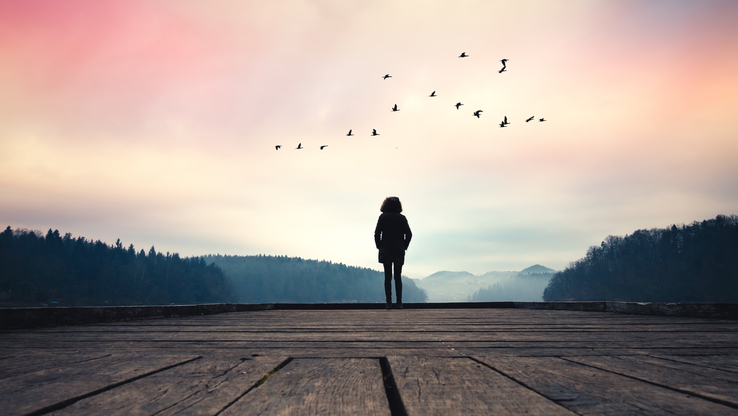 Woman standing by a lake