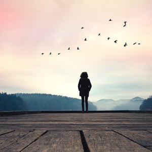 Woman standing by a lake